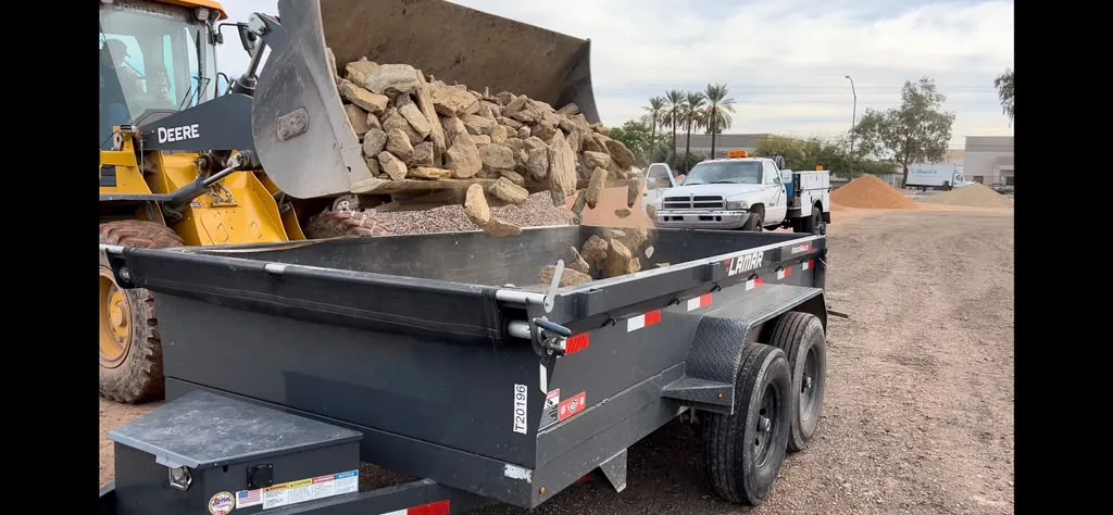 Trailer loaded with rock on the job site